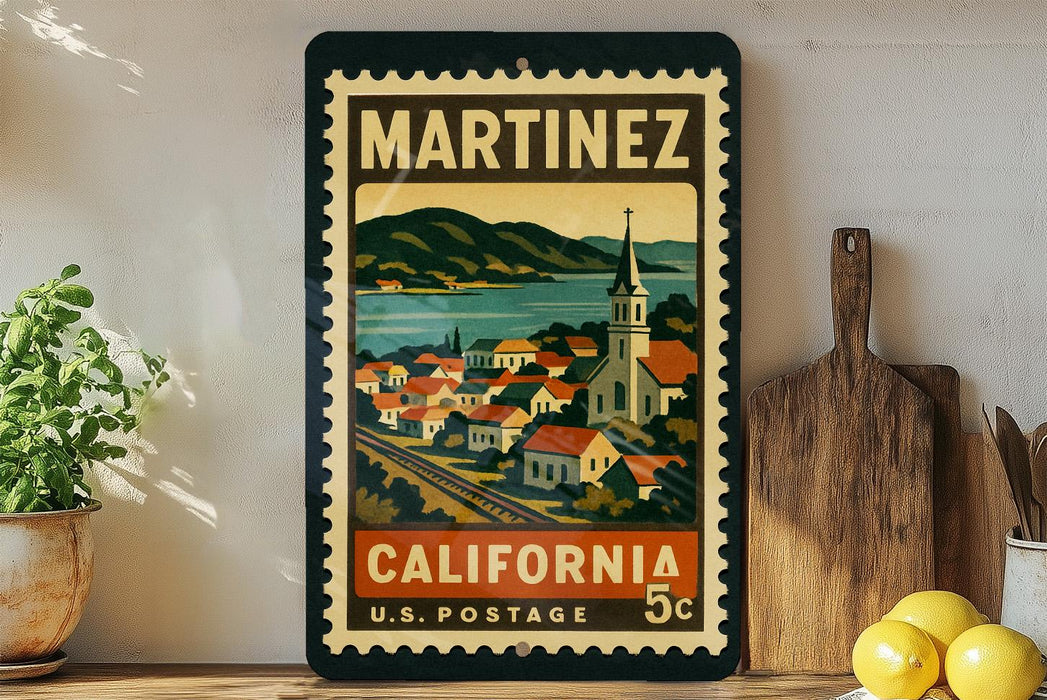 A vintage-style postage stamp from California, featuring a colorful illustration of a town and mountains, displayed on a shelf next to a wooden cutting board and some potted plants.