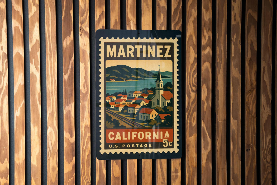 A vintage postage stamp from California, featuring a town and mountains, is displayed on a wooden wall.