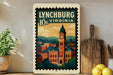 A framed illustration of Lynchburg, Virginia, featuring a clock tower and a cityscape, is displayed on a shelf next to a wooden cutting board and a potted plant.