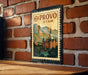 A vintage-style postage stamp depicting a scenic view of Utah, with mountains and a church in the background.