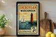 A vintage-style postage stamp from Wisconsin featuring a lighthouse and a sailboat, with the text "SHEBOYGAN WISCONSIN" and "U.S. POSTAGE 7c".