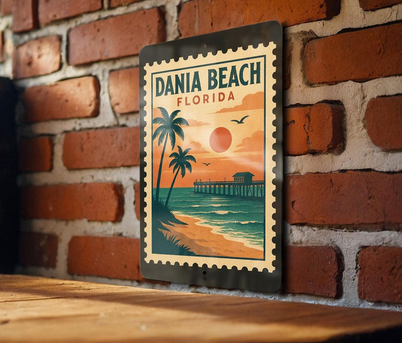 A vintage-style metal sign with a tropical beach scene, featuring palm trees, a pier, and a sunset over the ocean.