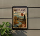 A postage stamp from Westland, Michigan, featuring a scenic landscape with a river, trees, and a building.