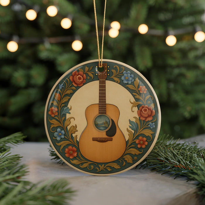 A decorative ornament featuring a guitar is displayed on a table, surrounded by pine branches and twinkling lights.