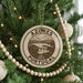 A circular ornament on a Christmas tree, featuring the text "AZORES PORTUGAL" and an illustration of a scenic landscape.