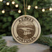 A circular ornament with the text "AZÓRES PORTUGAL" and an illustration of a scenic landscape, hanging from a string.