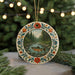 A decorative ornament featuring a fish swimming in a river, surrounded by a floral border, placed on a surface with pine branches and twinkling lights in the background.