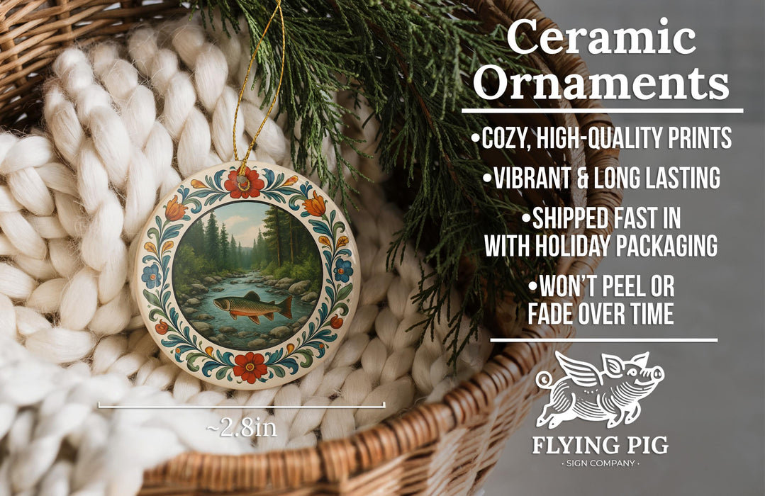 Ceramic ornaments, featuring a detailed image of a river and trees, are displayed in a woven basket.