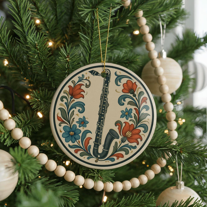 A Christmas tree decorated with ornaments, including a round ornament with a saxophone design and a string of wooden beads.