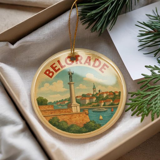 A decorative ornament with a circular design featuring a monument and a river, surrounded by greenery.