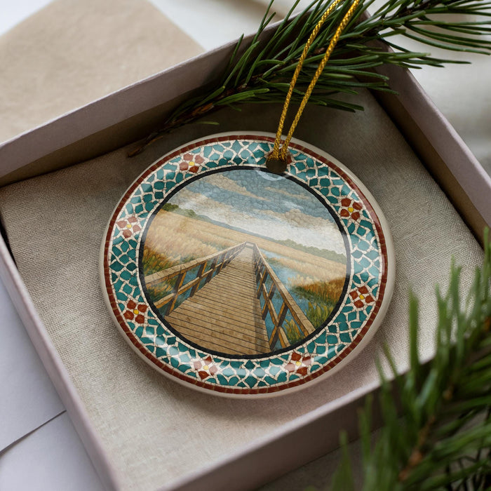 A decorative ornament in a box, featuring a wooden bridge and a scenic landscape.