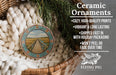 Ceramic ornaments, featuring a wooden bridge and a field, are displayed in a woven basket.