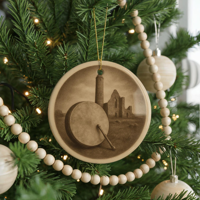 A Christmas tree decorated with ornaments, including a circular ornament featuring a castle and a drum.