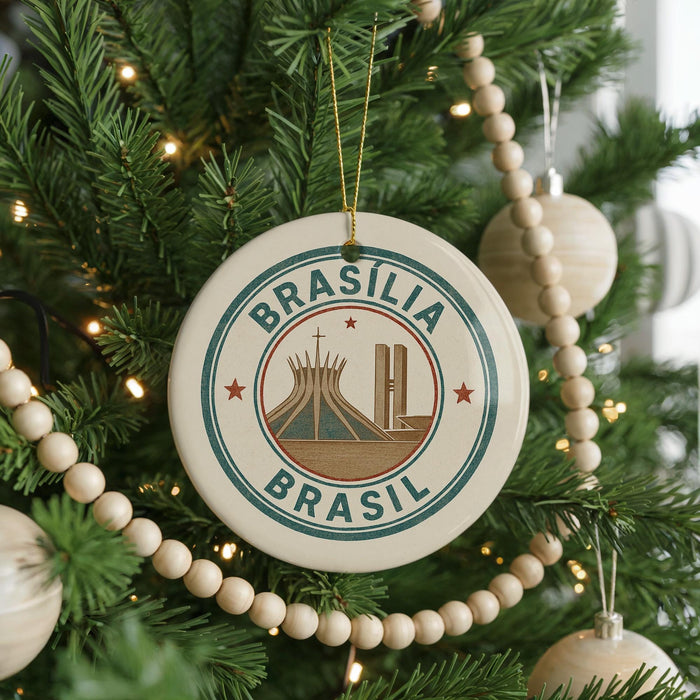 A Christmas tree decorated with ornaments, including a circular ornament with the text "BRASIL" and an illustration of the Christ Cathedral.