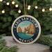 A round ornament with a blue border and a graphic of a coastal landscape, featuring the words "CABO SAN LUCAS MEXICO" in the center.