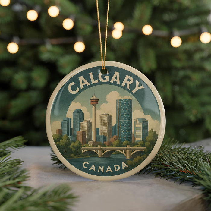 A circular ornament featuring a cityscape of Calgary, Canada, with a bridge and trees in the background.