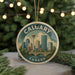 A circular ornament featuring a cityscape of Calgary, Canada, with a bridge and trees in the background.
