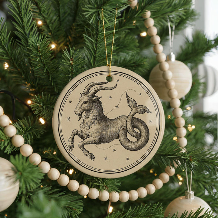 A Christmas tree decorated with ornaments, including a circular ornament featuring a zodiac symbol of a goat or ram.