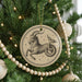 A Christmas tree decorated with ornaments, including a circular ornament featuring a zodiac symbol of a goat or ram.