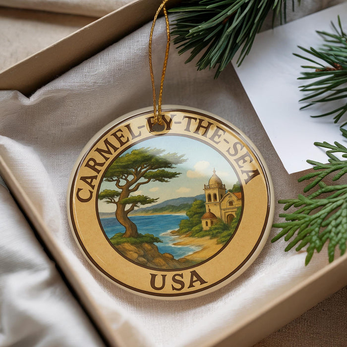 A decorative ornament with a circular design, featuring a tree and a building, is placed inside a box with pine branches.