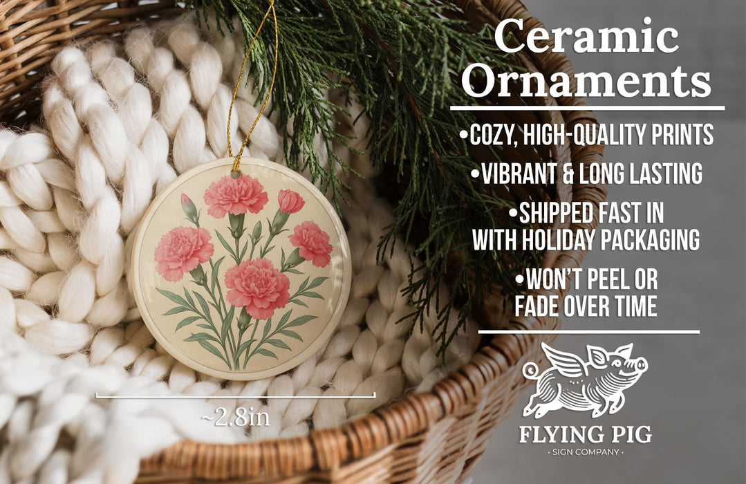 Ceramic ornaments with a floral design, including pink carnations, are displayed in a woven basket.