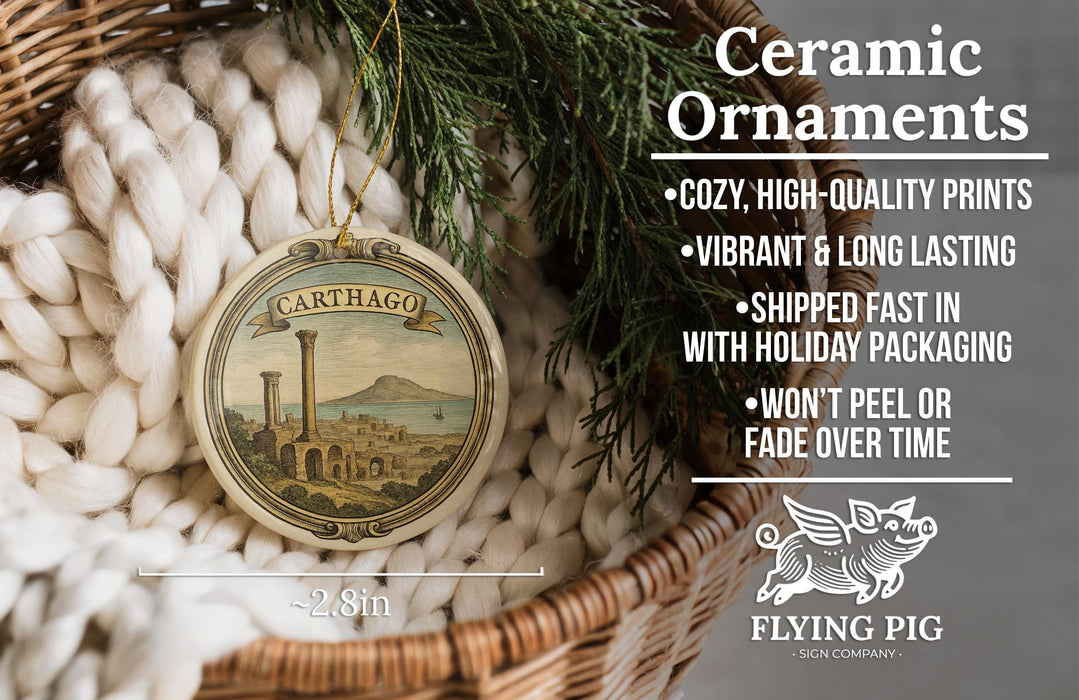 Ceramic ornaments, featuring a ceramic ornament with a cityscape design, are displayed in a woven basket.