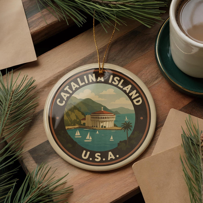 A circular ornament with the text "CATALINA ISLAND U.S.A." and a scenic illustration of Catalina Island, surrounded by pine branches and a cup of coffee.