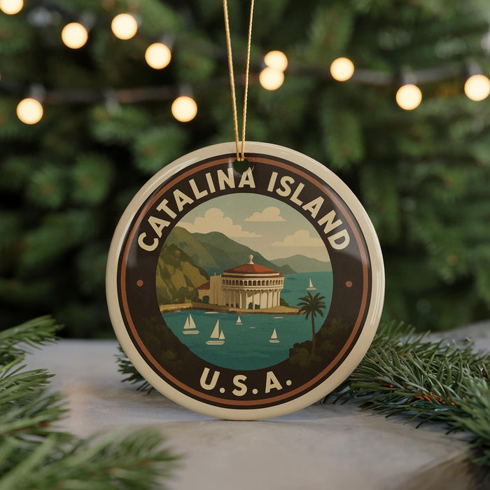 A circular ornament with the text "CATALINA ISLAND" and "U.S.A." printed on it, featuring a scenic image of Catalina Island with a building, palm trees, and boats in the water.