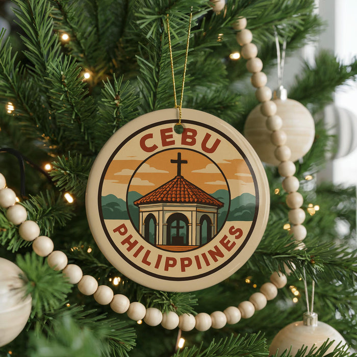 A Christmas tree decorated with ornaments, including a circular ornament with the text "CEBU PHILIPPINES" and a graphic of a building with a cross.