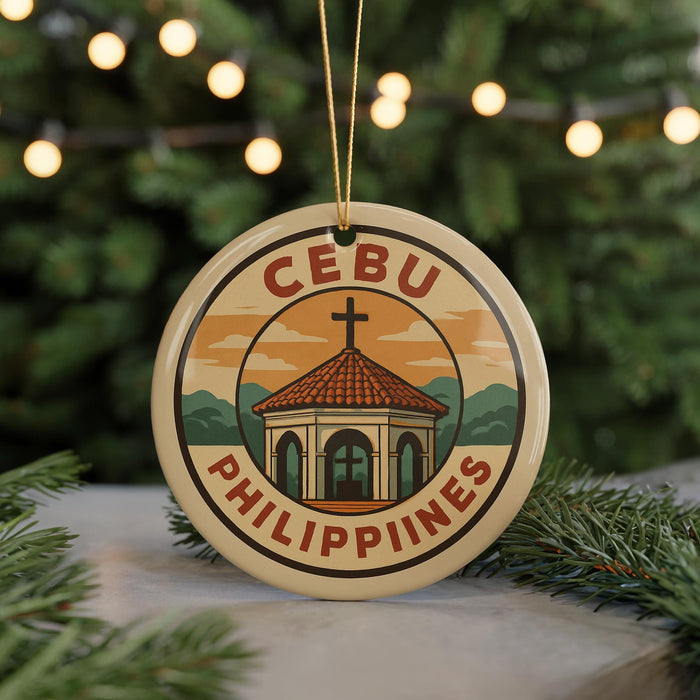 A round ornament with the text "CEBU PHILIPPINES" and an illustration of a church or cathedral, surrounded by Christmas lights and greenery.