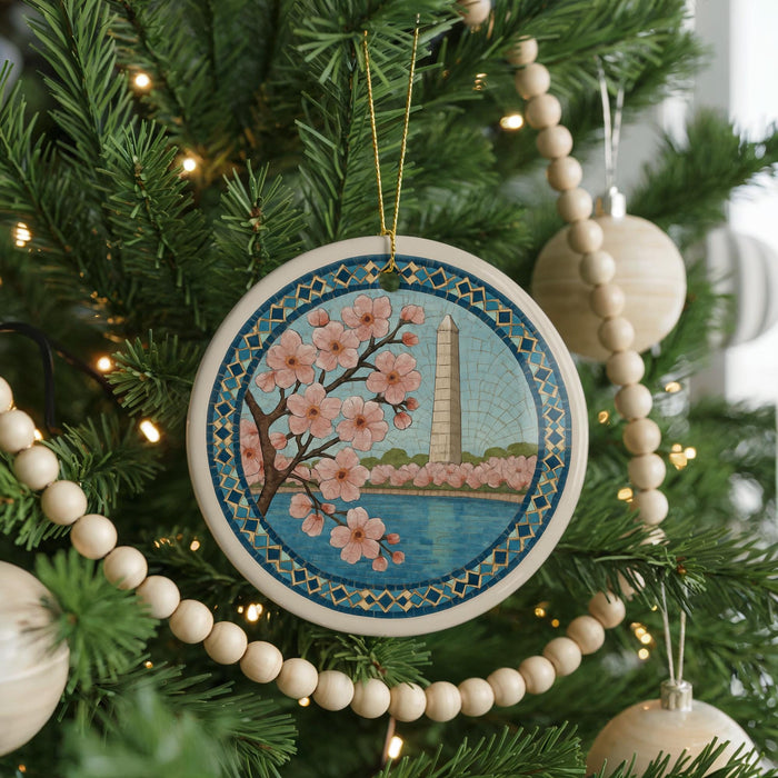 A Christmas tree decorated with ornaments, including a circular ornament featuring a floral design and a tower.