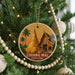 A round ornament on a Christmas tree, featuring a temple and palm trees, with the text "CHIANG MAI THAILAND" printed on it.