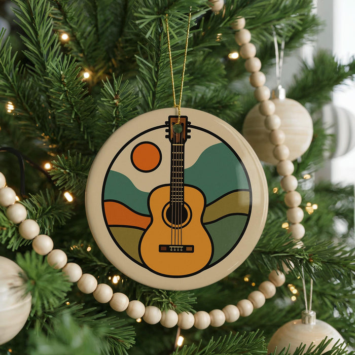 A Christmas tree decorated with a guitar ornament and wooden beads.