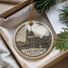 A circular ornament with a drawing of Cologne Cathedral in Germany, hanging from a string.