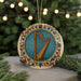 A decorative ornament featuring a harp is displayed on a table, surrounded by pine branches and twinkling lights.