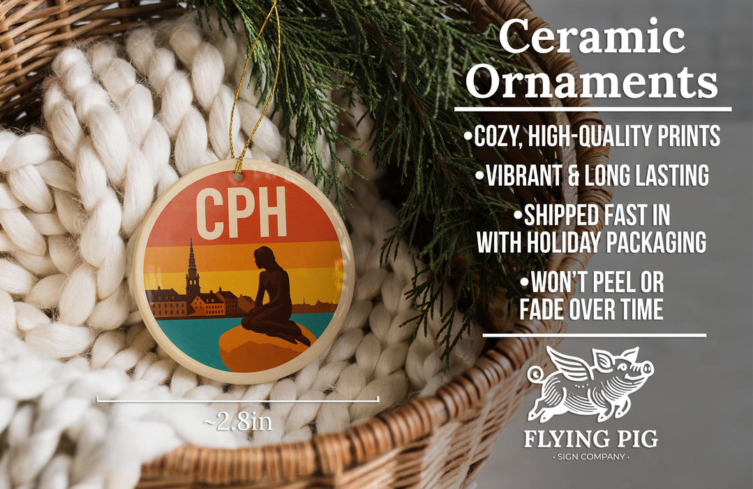 Ceramic ornaments, featuring a ceramic ornament with a silhouette of a person sitting on a rock, hanging from a wicker basket.