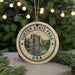 A circular ornament with the text "CUSTER STATE PARK USA" and an illustration of a mountain landscape, hanging from a string.