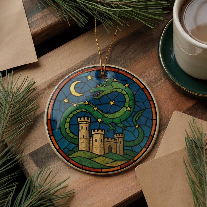 A decorative ornament featuring a green dragon with a castle in the background, set against a night sky with stars and a crescent moon.