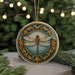 A decorative ornament featuring a dragonfly is displayed on a table, surrounded by pine branches and twinkling lights.