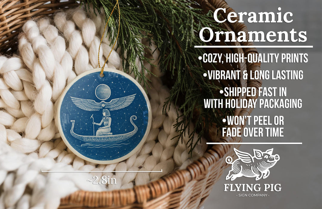 Ceramic ornaments, featuring a blue circular ornament with a winged figure and a boat, are displayed in a woven basket.
