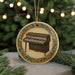 A round ornament featuring a piano on a Christmas tree, with a decorative border around the image.