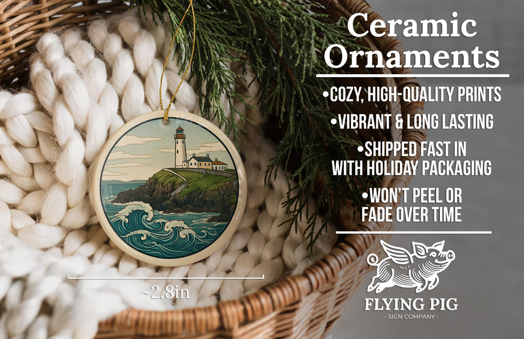 Ceramic ornaments, featuring a lighthouse on a cliff, are displayed in a basket with a pine branch.
