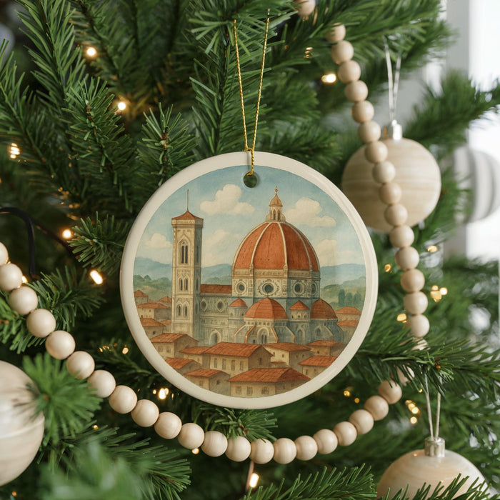 A Christmas tree decorated with ornaments, including a circular ornament featuring the iconic dome of Florence Cathedral, surrounded by a string of beads.