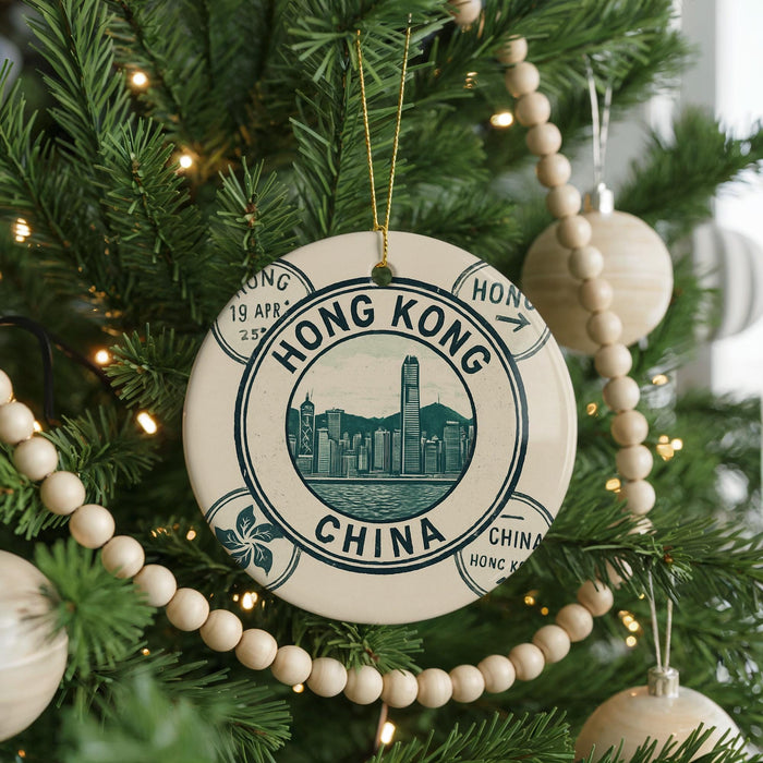 A decorative ornament on a Christmas tree, featuring a circular design with the text "HONG KONG CHINA" and an illustration of the Hong Kong skyline.