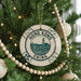 A decorative ornament on a Christmas tree, featuring a circular design with the text "HONG KONG CHINA" and an illustration of the Hong Kong skyline.