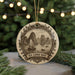 A decorative ornament featuring a sailing boat and mountains, with the text "HA LONG BAY VIRTHAM" around the edge.