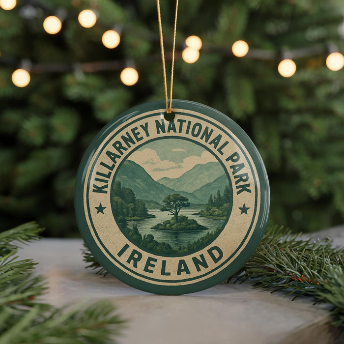 A circular ornament with the text "KILARNEY NATIONAL PARK IRELAND" and a scenic landscape of mountains and a lake, hanging from a string.