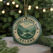 A circular ornament with the text "KILARNEY NATIONAL PARK IRELAND" and a scenic landscape of mountains and a lake, hanging from a string.