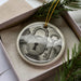 A ceramic ornament in a box, featuring a lock and key design.