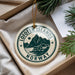 A circular ornament with the text "Lofoten Islands NORWAY" printed on it, hanging from a string.